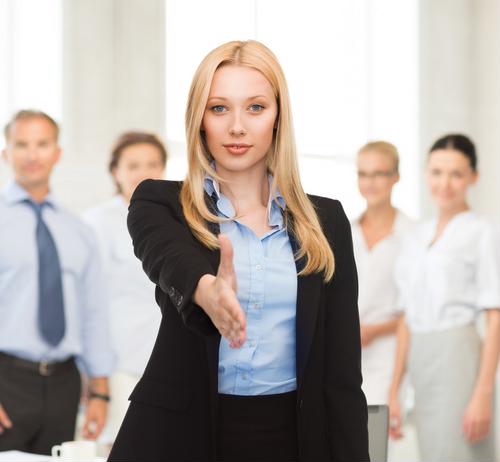 A group of employees and their boss welcoming a new employee. 