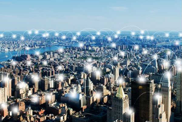 Wireless WAN over city visualized through white arcs of light.