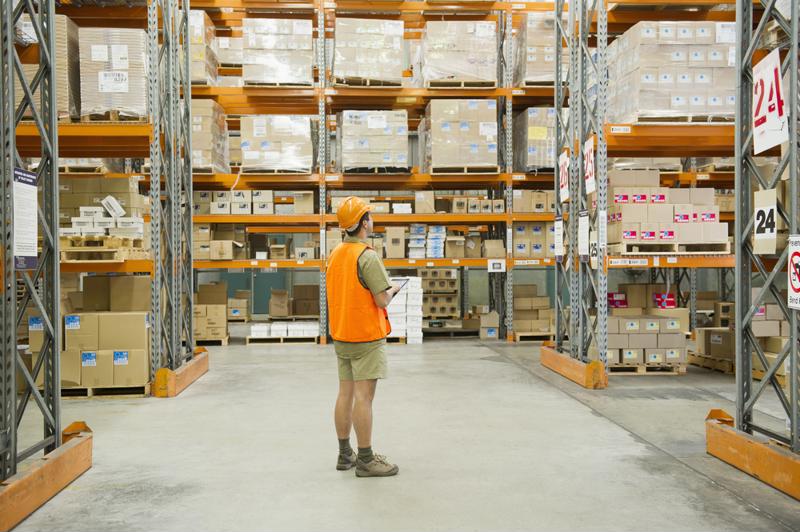 Warehouse worker taking inventory.