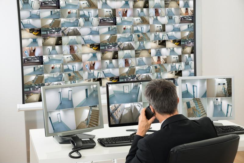 Security guard watches camera monitors