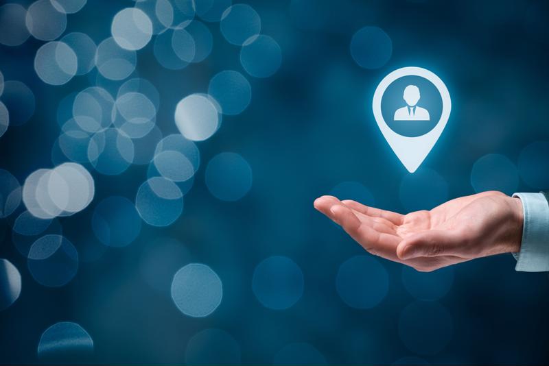 A hand holds a customer icon.