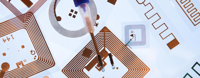 Worker adjusting small RFID chips .